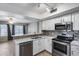 Charming kitchen with stainless steel appliances, modern cabinetry, and views to the living space at 4948 W Wikieup Ln, Glendale, AZ 85308