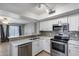 Updated kitchen featuring white cabinets, stainless steel appliances and stone backsplash at 4948 W Wikieup Ln, Glendale, AZ 85308