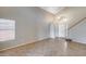 Bright living room with tile floors, high ceilings, and neutral paint, creating an inviting space at 4948 W Wikieup Ln, Glendale, AZ 85308