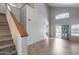 Spacious living room with high ceilings, tile flooring, staircase, and sliding glass doors leading to the backyard at 4948 W Wikieup Ln, Glendale, AZ 85308