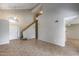 Open concept living area featuring a staircase, tile floors, and views into the kitchen, dining, and front entryway at 4948 W Wikieup Ln, Glendale, AZ 85308