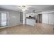Spacious living room featuring tile flooring and easy access to the updated kitchen at 4948 W Wikieup Ln, Glendale, AZ 85308
