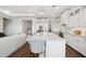 Bright, open kitchen featuring modern lighting, a large center island, and stainless steel appliances at 521 E Aurora Dr, San Tan Valley, AZ 85140