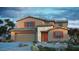 Inviting two-story home featuring a stone facade, red shutters, desert landscaping, and a two car garage at 5355 W Sweet Pea Ter, Laveen, AZ 85339