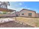 View of the backyard featuring a partially covered patio and block wall at 537 W Kingman Dr, Casa Grande, AZ 85122