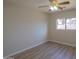 Bedroom with ceiling fan and view to the exterior at 537 W Kingman Dr, Casa Grande, AZ 85122