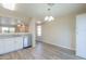Cozy dining area with modern chandelier, updated flooring, and stainless steel appliances at 537 W Kingman Dr, Casa Grande, AZ 85122