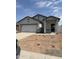 New construction single-story home with a white garage door and desert landscaping at 5702 E Iris Dr, Florence, AZ 85132