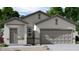Charming single-story home with a neutral stucco exterior, two-car garage, and manicured landscaping at 5702 E Iris Dr, Florence, AZ 85132