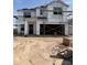 New home construction featuring a two-story design with visible framework and covered with protective moisture wrap material at 6008 E Artemis Dr, Florence, AZ 85132