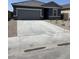 This single-story home features a two-car garage, neutral color scheme, and low-maintenance landscaping at 6041 E Artemis Dr, Florence, AZ 85132