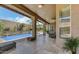 Inviting covered patio with stone flooring, a pool and seating area perfect for outdoor living at 7418 E Black Rock Rd, Scottsdale, AZ 85255