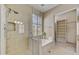 Bathroom highlighting glass shower, soaking tub, and closet space with ample natural light at 7418 E Black Rock Rd, Scottsdale, AZ 85255