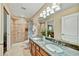 Bathroom with a double sink vanity, walk-in shower, and neutral tile at 7418 E Black Rock Rd, Scottsdale, AZ 85255