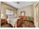 Bright bedroom with hardwood floors featuring a ceiling fan, window blinds, and wood furnishings at 7418 E Black Rock Rd, Scottsdale, AZ 85255
