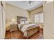 Cozy bedroom featuring dark hardwood floors, a ceiling fan, and natural lighting at 7418 E Black Rock Rd, Scottsdale, AZ 85255