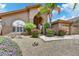 Charming desert home with a two-car garage, mature landscaping, and an arched entryway at 7418 E Black Rock Rd, Scottsdale, AZ 85255
