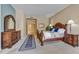 Comfortable main bedroom with a wood bed frame, dresser, ensuite bathroom, and carpet floors at 7418 E Black Rock Rd, Scottsdale, AZ 85255