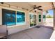 Covered back patio featuring a ceiling fan, pavers, a light-colored wall, and a view of the pool and backyard at 7435 W Trails Dr, Glendale, AZ 85308