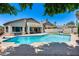 Private backyard featuring a sparkling pool, patio area for entertaining, and lush desert landscaping at 7435 W Trails Dr, Glendale, AZ 85308