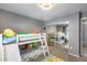 A bedroom featuring carpet flooring, a chandelier ceiling fan, a bunk bed with a slide, and curtains at 7435 W Trails Dr, Glendale, AZ 85308