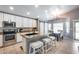 Bright kitchen with granite counters, stainless steel appliances, and adjacent dining area with stylish lighting at 7435 W Trails Dr, Glendale, AZ 85308