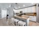 Modern kitchen with granite countertops, white cabinetry, and a convenient center island with seating at 7435 W Trails Dr, Glendale, AZ 85308