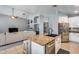 Modern kitchen with granite island, stainless appliances, and a view to the comfortable living room at 7435 W Trails Dr, Glendale, AZ 85308