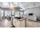 Open kitchen island with granite counters, seating, seamlessly connecting the kitchen and living areas at 7435 W Trails Dr, Glendale, AZ 85308