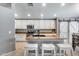 Bright kitchen showcasing white cabinets, granite counters, and modern appliances, plus stylish barn doors at 7435 W Trails Dr, Glendale, AZ 85308