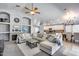 Open-concept living room showcases a cozy fireplace, plush seating, and seamless flow to the kitchen at 7435 W Trails Dr, Glendale, AZ 85308