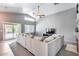 Spacious living room with vaulted ceilings, plush seating, and sliding glass doors to the backyard at 7435 W Trails Dr, Glendale, AZ 85308