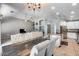 Open-concept living and dining area boasts a modern kitchen with stainless steel appliances and a granite countertop at 7435 W Trails Dr, Glendale, AZ 85308