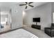 Main bedroom with a TV, sitting area, and a glimpse into the en-suite bathroom, offering relaxation at 7435 W Trails Dr, Glendale, AZ 85308