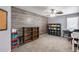 Home office with carpet flooring, ample shelving, and a feature wall for added charm at 7435 W Trails Dr, Glendale, AZ 85308