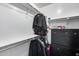 Organized walk-in closet featuring a shelf, hanging rods, clothes, suitcase, and a black dresser with drawers at 7435 W Trails Dr, Glendale, AZ 85308