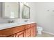 Bright bathroom featuring double sinks and vanity, with tile floors at 7526 W Windrose Dr, Peoria, AZ 85381