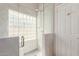 Elegant bathroom with tiled glass block window shower and white door at 7526 W Windrose Dr, Peoria, AZ 85381