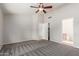 Large bedroom with neutral carpet and ceiling fan at 7526 W Windrose Dr, Peoria, AZ 85381