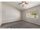 Bright bedroom with neutral paint, carpet and view to the outdoors at 7526 W Windrose Dr, Peoria, AZ 85381