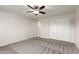 Bedroom featuring plush carpeting, neutral walls, a ceiling fan, and a closet at 7526 W Windrose Dr, Peoria, AZ 85381
