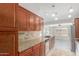 Modern kitchen featuring stainless steel appliances, tile backsplash, and granite counters at 7526 W Windrose Dr, Peoria, AZ 85381