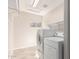 Functional laundry room with tile flooring, shelving, and modern appliances at 7526 W Windrose Dr, Peoria, AZ 85381