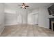 Spacious living area boasting tile floors, neutral colors, and a fireplace with a TV above at 7526 W Windrose Dr, Peoria, AZ 85381