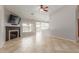 Open-concept living area with fireplace and views of the backyard pool from a window at 7526 W Windrose Dr, Peoria, AZ 85381