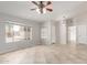 Inviting living room features tile flooring, a ceiling fan and ample natural light at 7526 W Windrose Dr, Peoria, AZ 85381