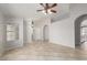 Bright open-concept living space with arched doorways, tile flooring, and modern ceiling fan at 7526 W Windrose Dr, Peoria, AZ 85381