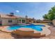 Inviting pool and patio area, perfect for entertaining and relaxation, against the backdrop of the charming home at 7526 W Windrose Dr, Peoria, AZ 85381