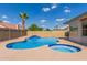 Sparkling blue pool with attached spa and serene water feature, surrounded by a spacious patio, ideal for relaxing at 7526 W Windrose Dr, Peoria, AZ 85381