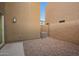 Backyard area with gravel, concrete patio and air conditioning unit at 8253 W Illini St, Phoenix, AZ 85043